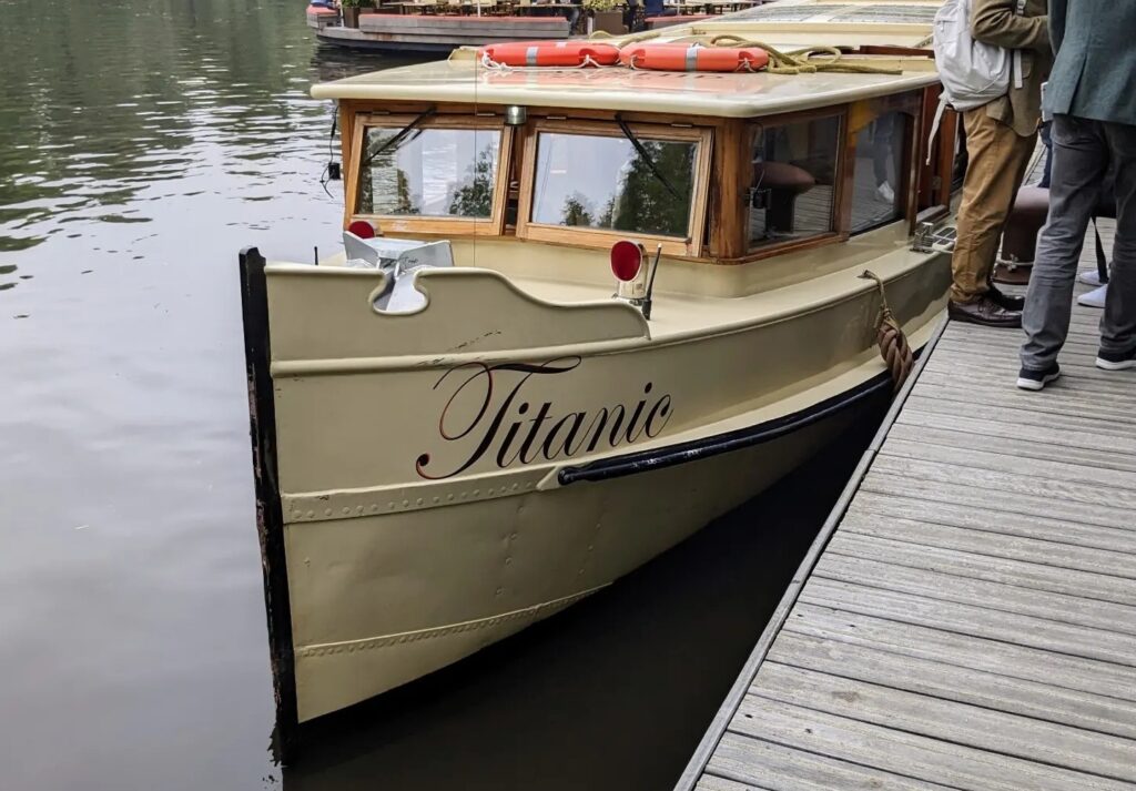 Photo of a canal boat in Amsterdam with the name "Titanic" written on the bow.