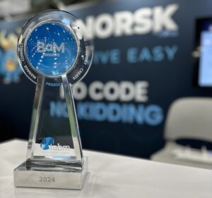 IABM BaM award in front of the Norsk booth at NAB 2024